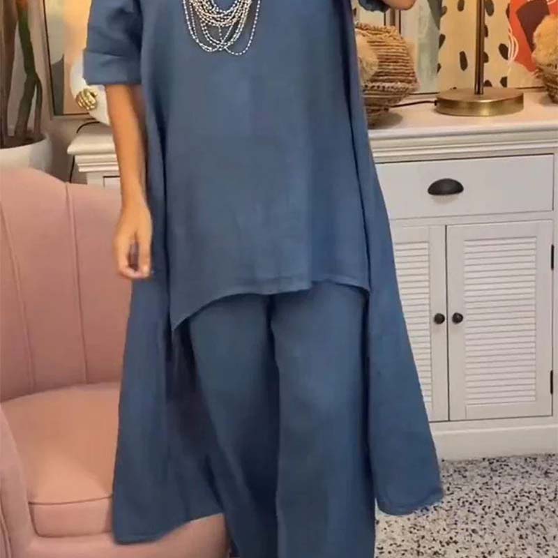 Set de dos partes de las mujeres: tapa asimétrica y pantalones